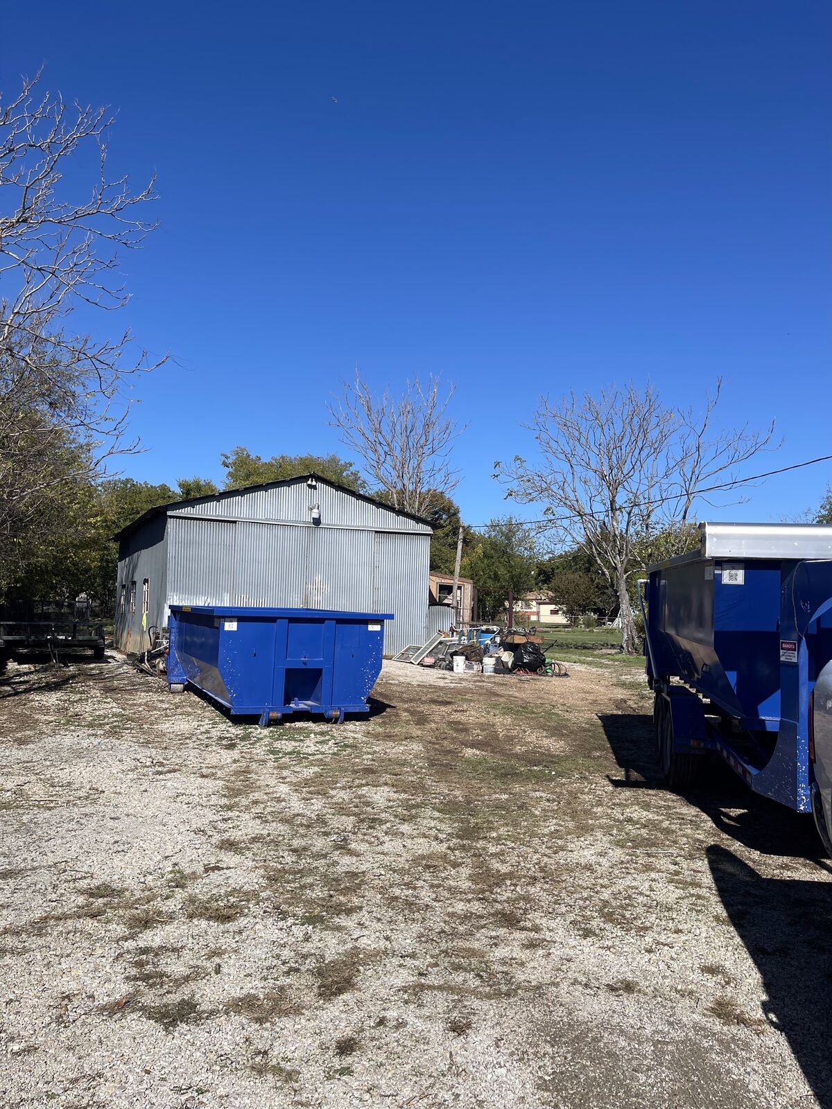 Bluebonnet Roll Offs dumpster and hauling trailer at our Rowlett yard
